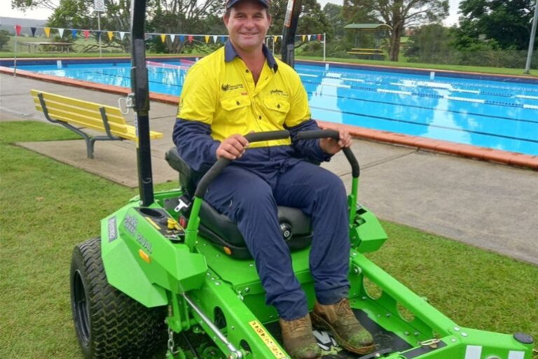 Glenn Campbell, Precinct Inspector for Swim, Sport & fitness, cutting grass at Milton Pool.