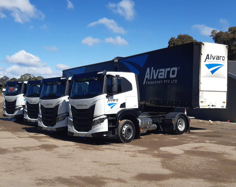 Alvaro Transport trucks and trailer in yard