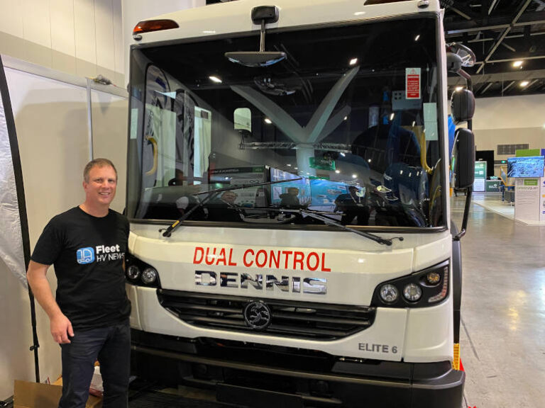 Marc Sibbald standing in front of the Dennis Eagle waste truck sold by Penske